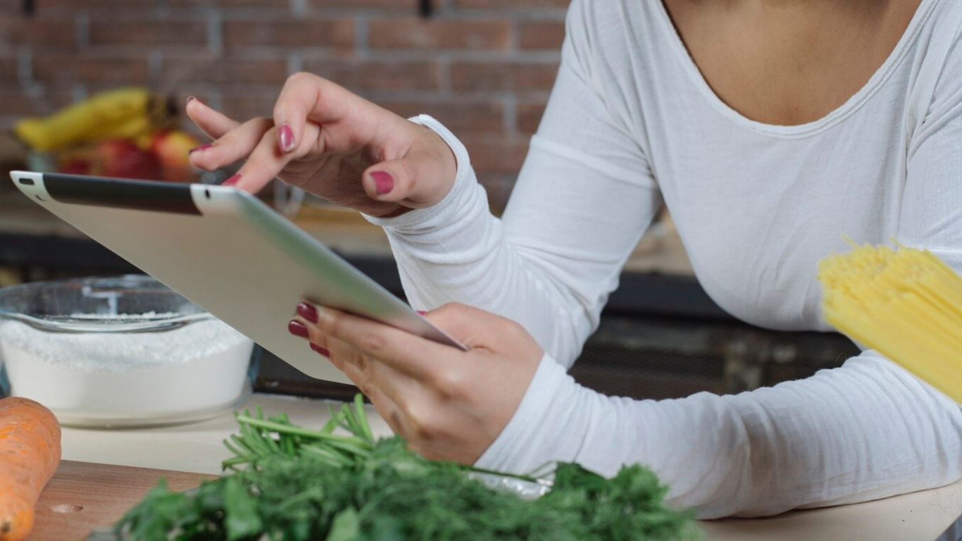 Moça comendo um prato saudável e pesquisando sobre a síndrome de dumping